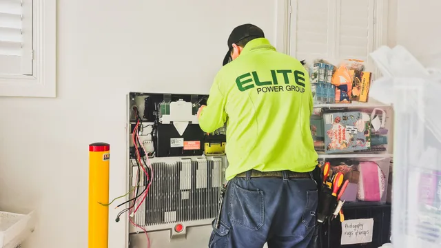 A technician from Elite Power Group installing a home battery system indoors in New South Wales, Australia. Getting garage door service packages right the first time