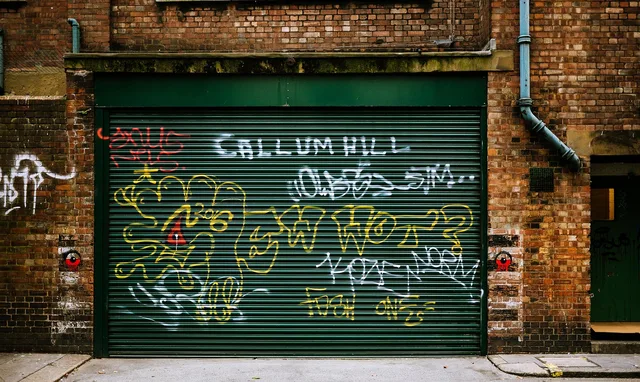 art, brick, brick wall, building, door, drawings, garage door, graffiti, overhead door, pavement, vandalism, wall, brick wall, garage door, garage door, garage door, garage door, garage door, graffiti, graffiti, vandalism, vandalism. What garage door service software should measure