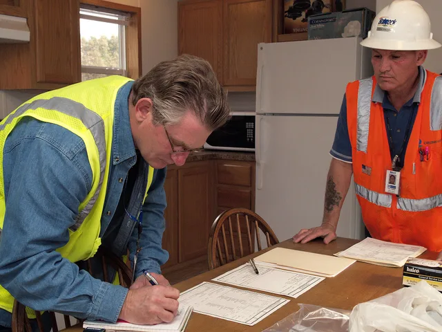 Delzura, CA, December 8, 2007 -- After inspecting the mobile home, Mark Ares, left, of CH2M Hill, Inc., signs paperwork signifying that Don Keller and his team from Babcock Services, Inc., right, have completed the contracting work necessary to prepare it for occupancy. FEMA workers will decide whet. Garage door service package ideas: write exclusions first