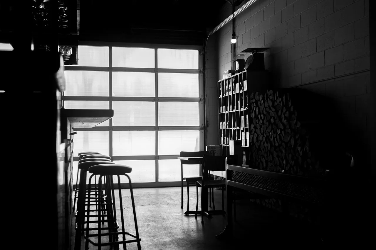 bar, stools, garage, black and white, black garage, gray garage. 3 ways provincial building codes change garage door work in Nova Scotia and BC